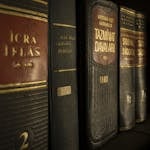 Detailed close-up of law and regulation books on a bookshelf, emphasizing education and knowledge.